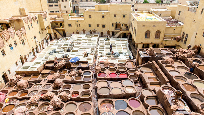Image of a bustling market square or souk in Marrakech, Morocco